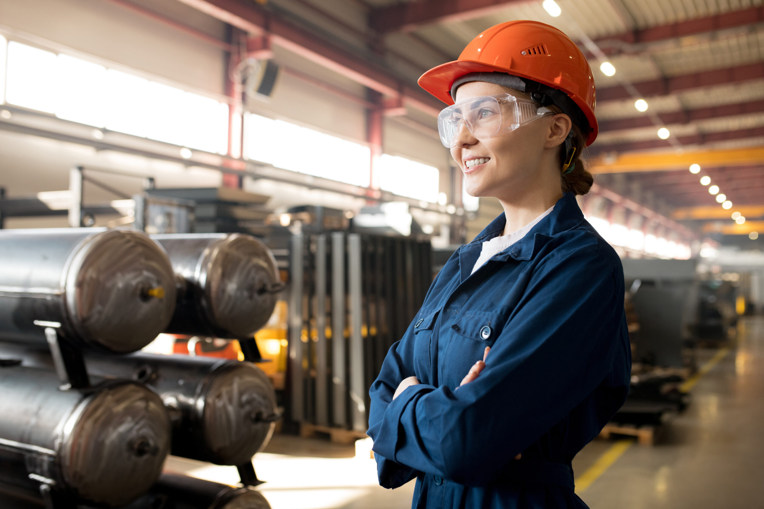 Young female technician wearing safety glasses and hard hat