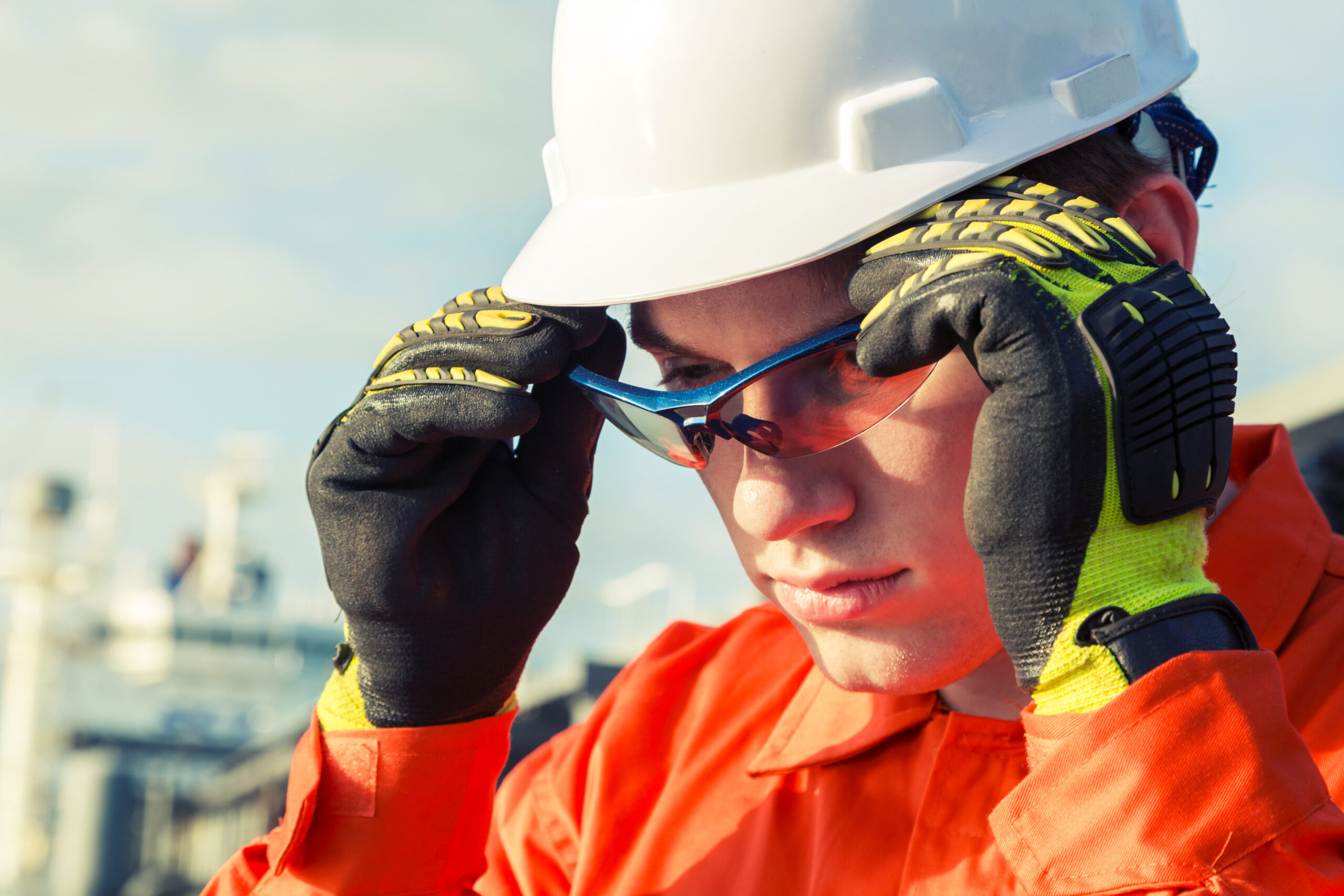 construction worker putting on safety glasses